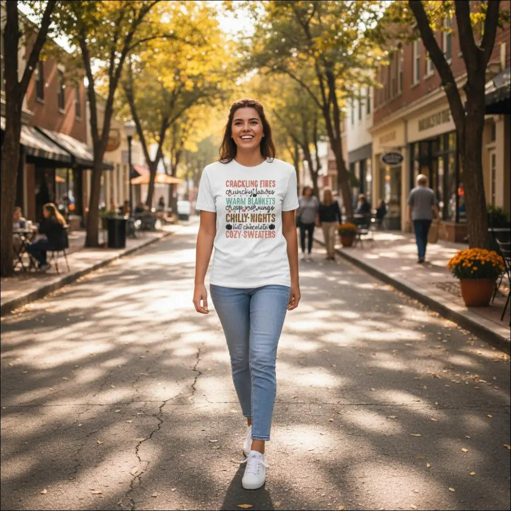 White heavyweight cotton t-shirt with pink and teal text: crackling fires, crunchy snacks, warm blankets, cozy nights