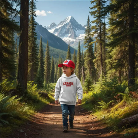 Child in white Canada Est. 1867 hoodie and red flag cap