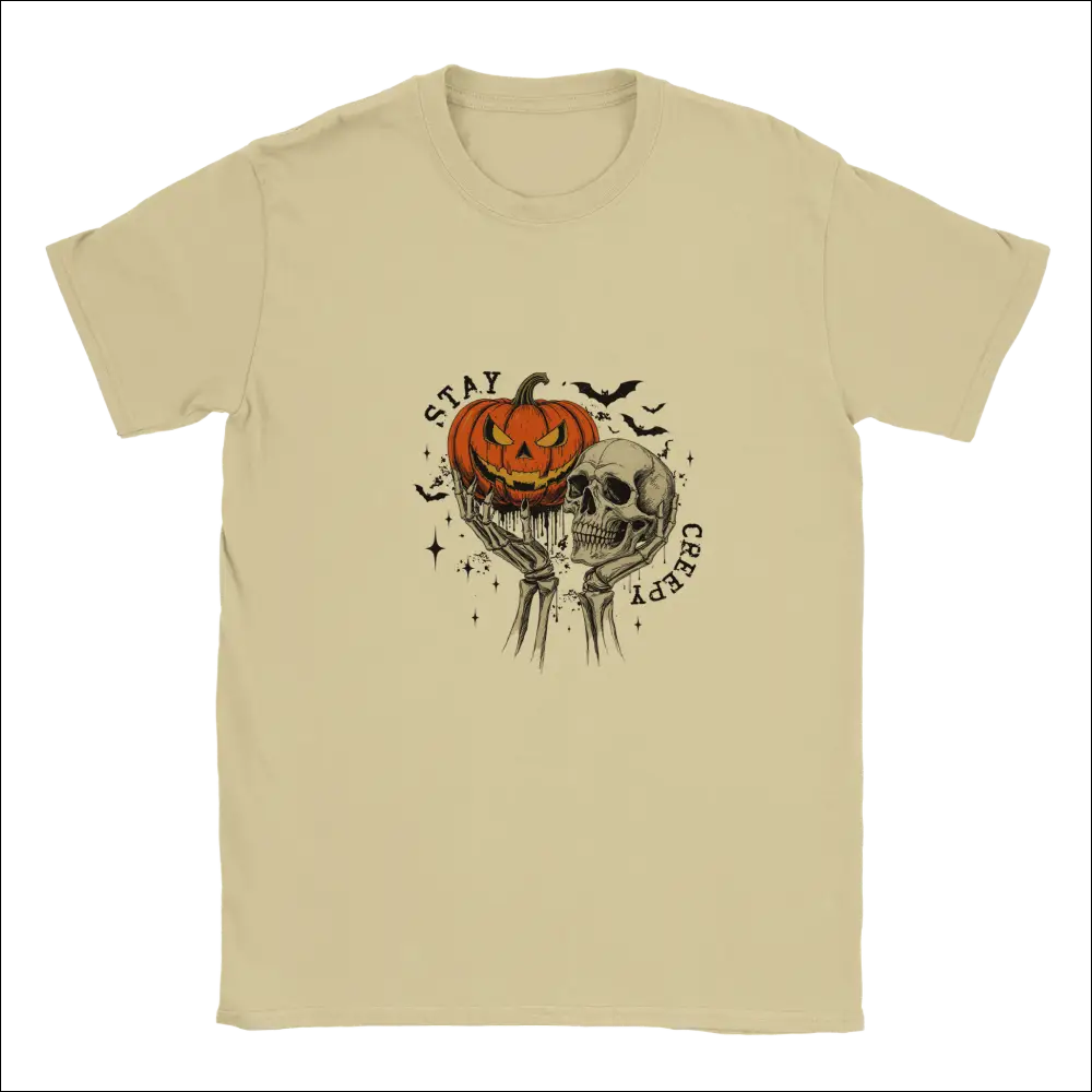 Beige Stay Creepy unisex t-shirt with skeletal hands, glowing orange pumpkin, skull, and arched text