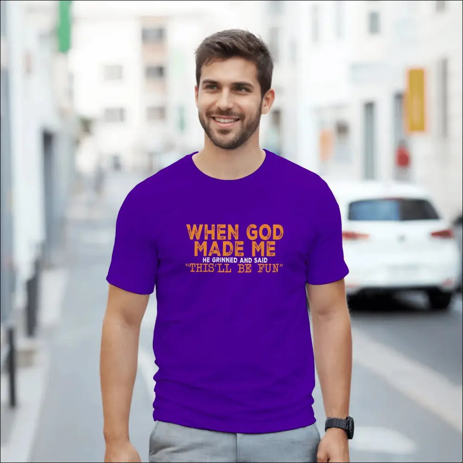 Purple short-sleeved t-shirt with orange text: when god made me he grinned and said this ll be fun. Heavyweight cotton classic fit