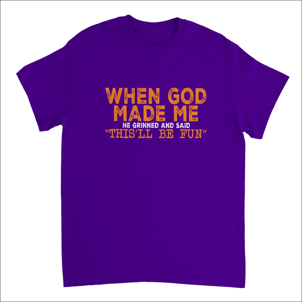 Purple short-sleeved t-shirt with orange text: When god made me he grinned and said thisll be fun. Heavyweight cotton classic fit