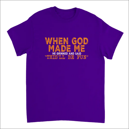 Purple short-sleeved t-shirt with orange text: When god made me he grinned and said thisll be fun. Heavyweight cotton classic fit