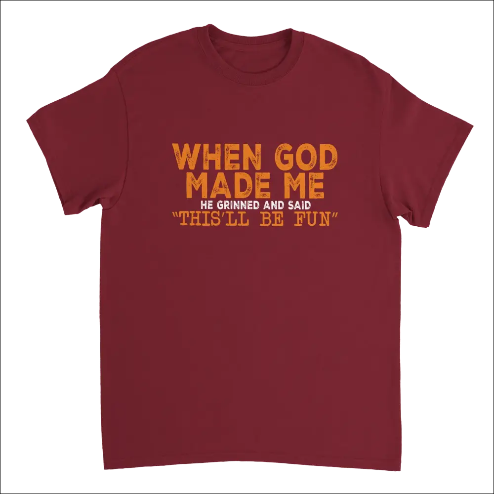 Maroon short-sleeved t-shirt with orange distressed text: When god made me he grinned and said thisll be fun