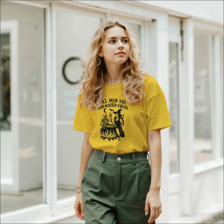 Yellow unisex Halloween tee with witch, skeleton, and cauldron print