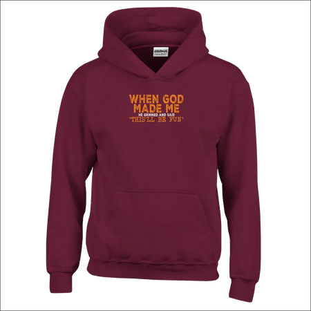 Maroon kids hoodie with orange text: When God Made Me He Grinned and Said This Will Be Fun